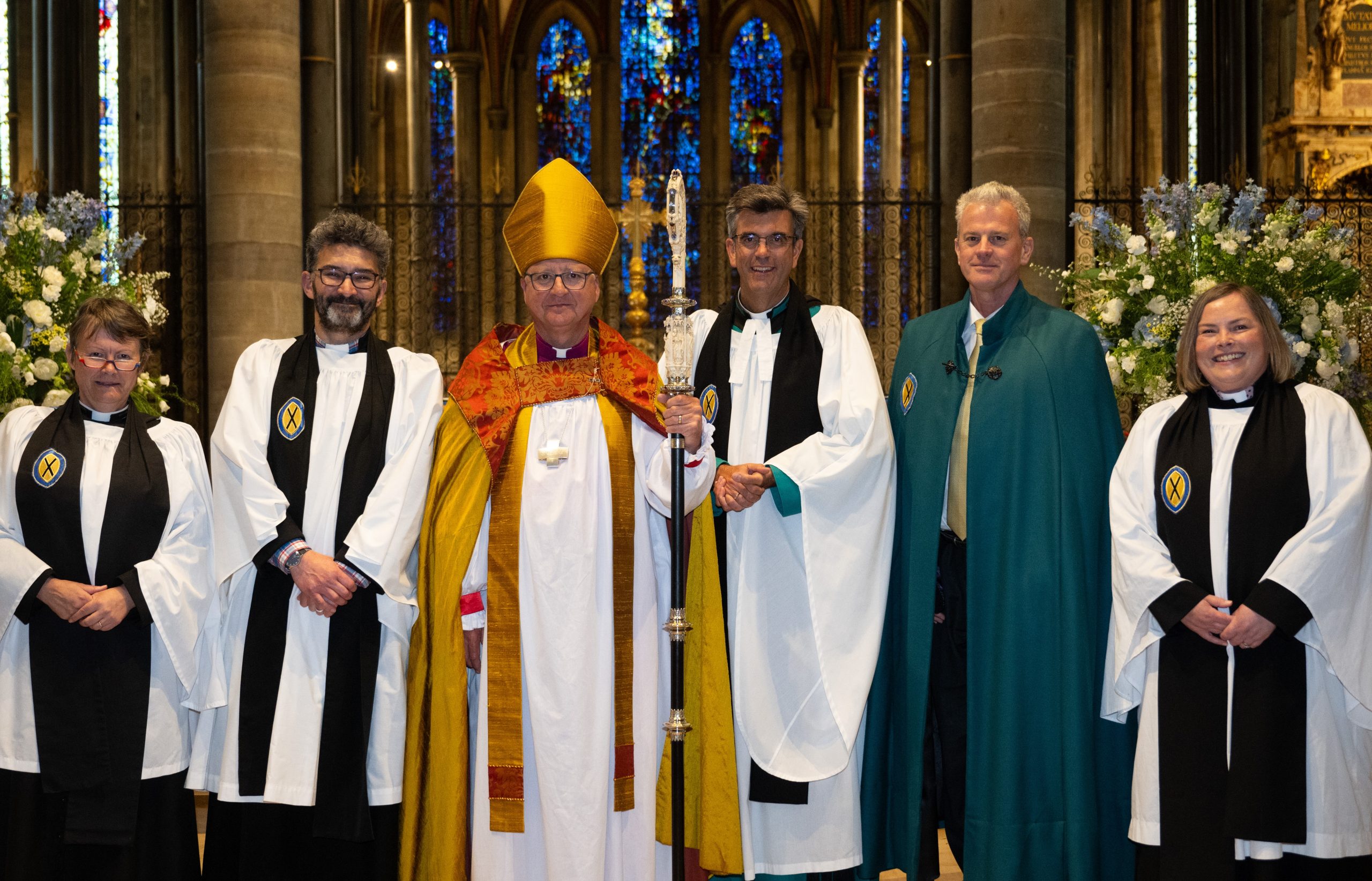 Picture of four canons standing next to the Bishop and Dean in garments