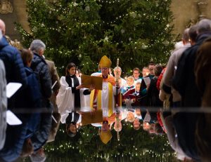 Bishop of Salisbury leads Christmas Day Service with Christmas tree in background