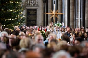 A child processes down the nave holding a star