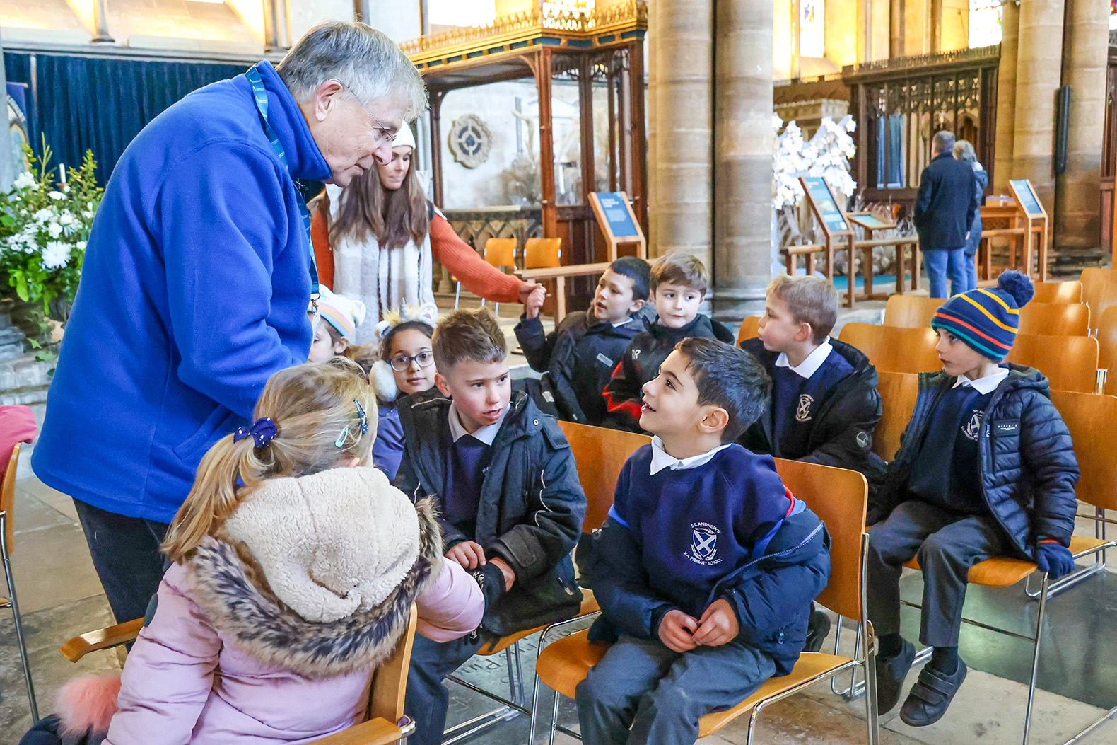 School children sat on chairs inside the Cathedral